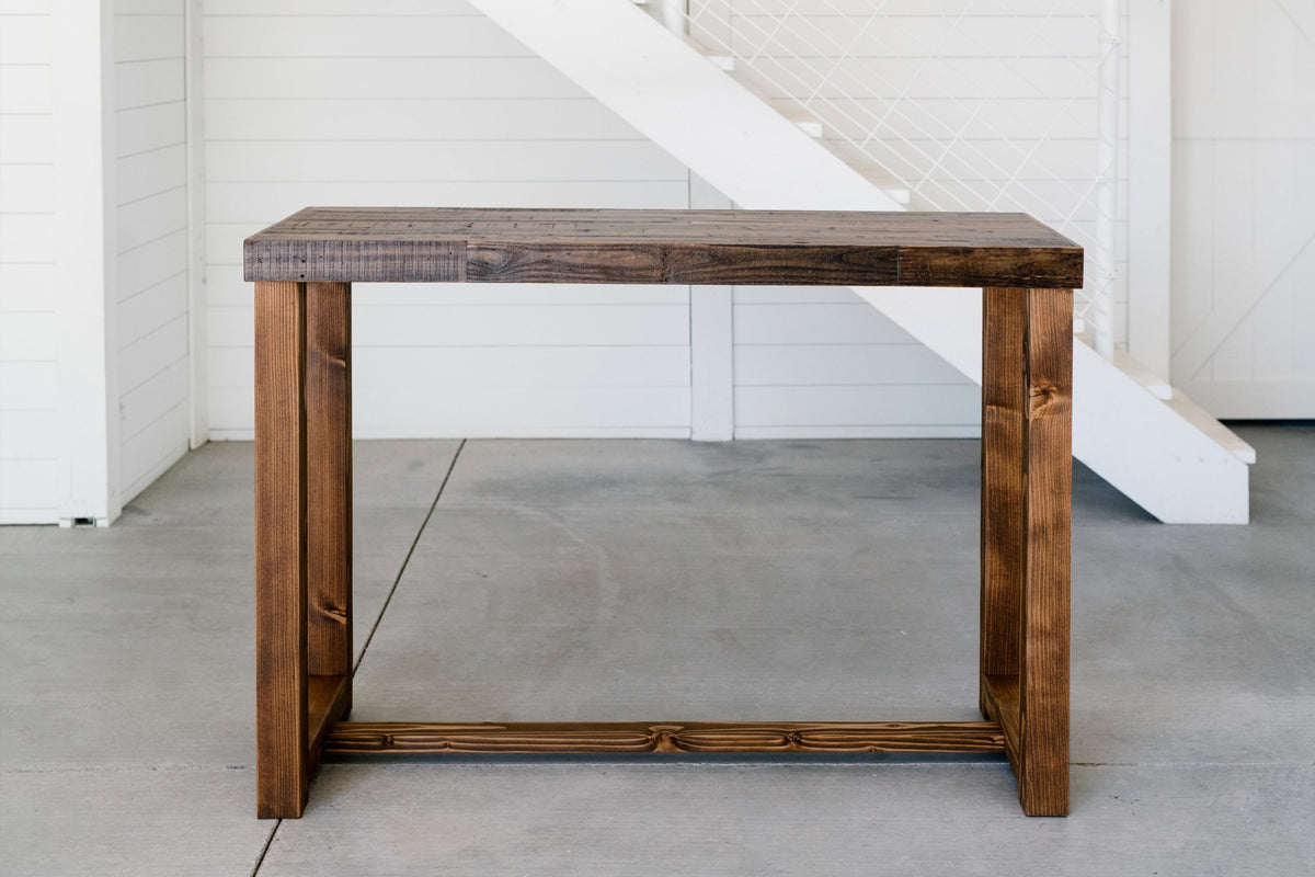 Handcrafted in Arizona, this reclaimed wood bar-height table features a sleek rectangular top and straight legs. Ideal as a narrow kitchen island or restaurant counter table, it highlights sustainable craftsmanship and enduring style.