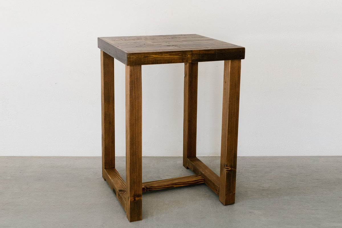 Handcrafted in Arizona, this bar-height table and matching wooden stool showcase enduring quality with a natural brown finish. Made from sustainable reclaimed wood, perfect as a narrow bar table or kitchen island.