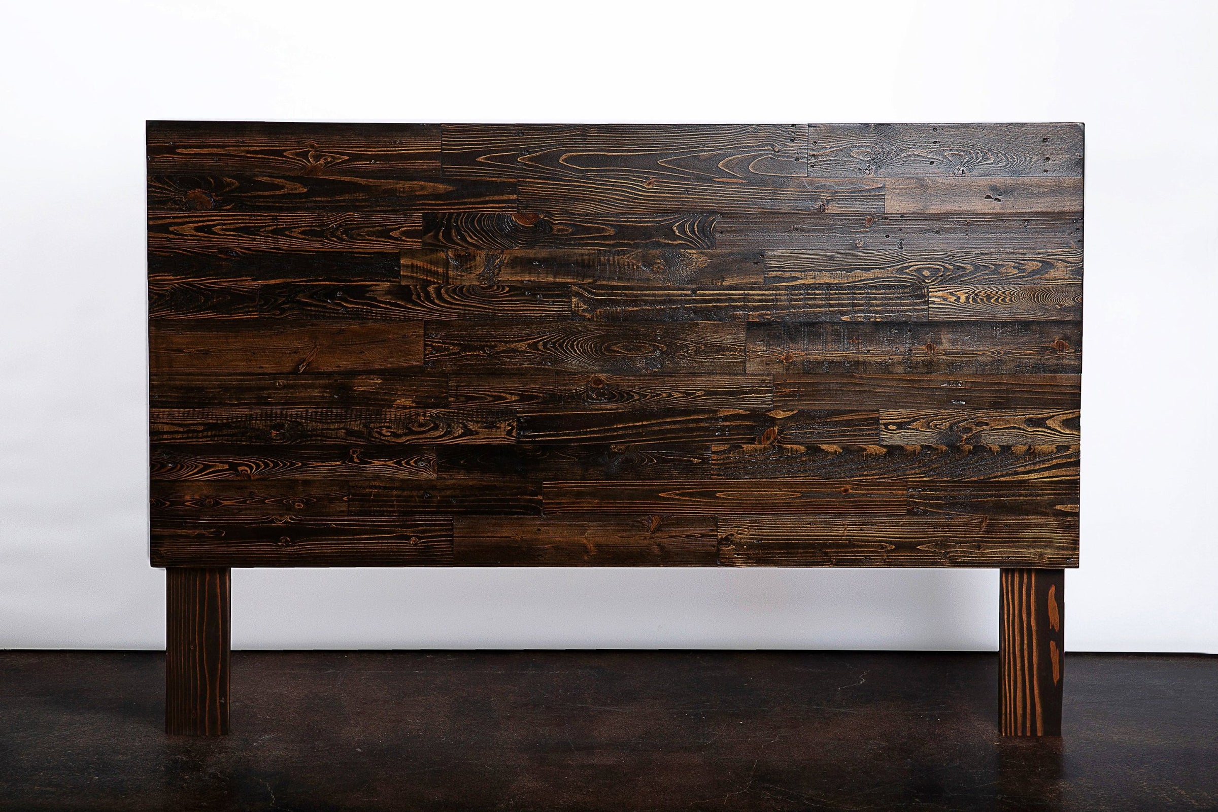 Expertly handcrafted in Arizona, this headboard showcases enduring quality with dark-stained reclaimed wood and a horizontal plank design. Part of our sustainable reclaimed wood furniture collection for timeless style.