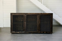 Handcrafted in Arizona, this reclaimed wood sideboard features three mesh-front doors, showcasing artisan craftsmanship and enduring quality. Ideal as a kitchen island or dining room storage, it embodies sustainable furniture design.