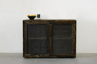 Experience timeless design with this handcrafted reclaimed wood sideboard, featuring durable metal door insets. Perfect as a narrow bar table or kitchen island, it brings enduring quality and warmth to any space.