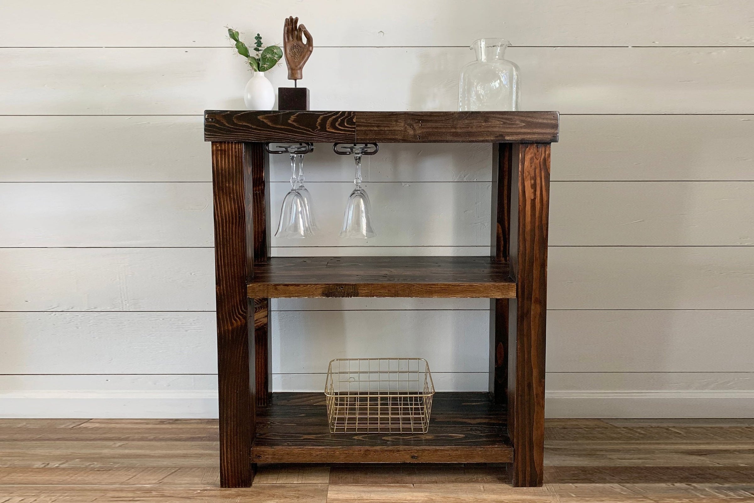 Expertly crafted in Arizona, this reclaimed wood bar cart showcases artisanal quality with two spacious shelves, a wire basket, and elegant décor accents—ideal as a narrow bar table or unique reclaimed wood furniture piece.