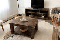 This inviting living room features handcrafted reclaimed wood furniture, including a customizable rectangle coffee table and TV stand. Perfect for those seeking sustainable, enduring quality in their coffee or bar-height tables.