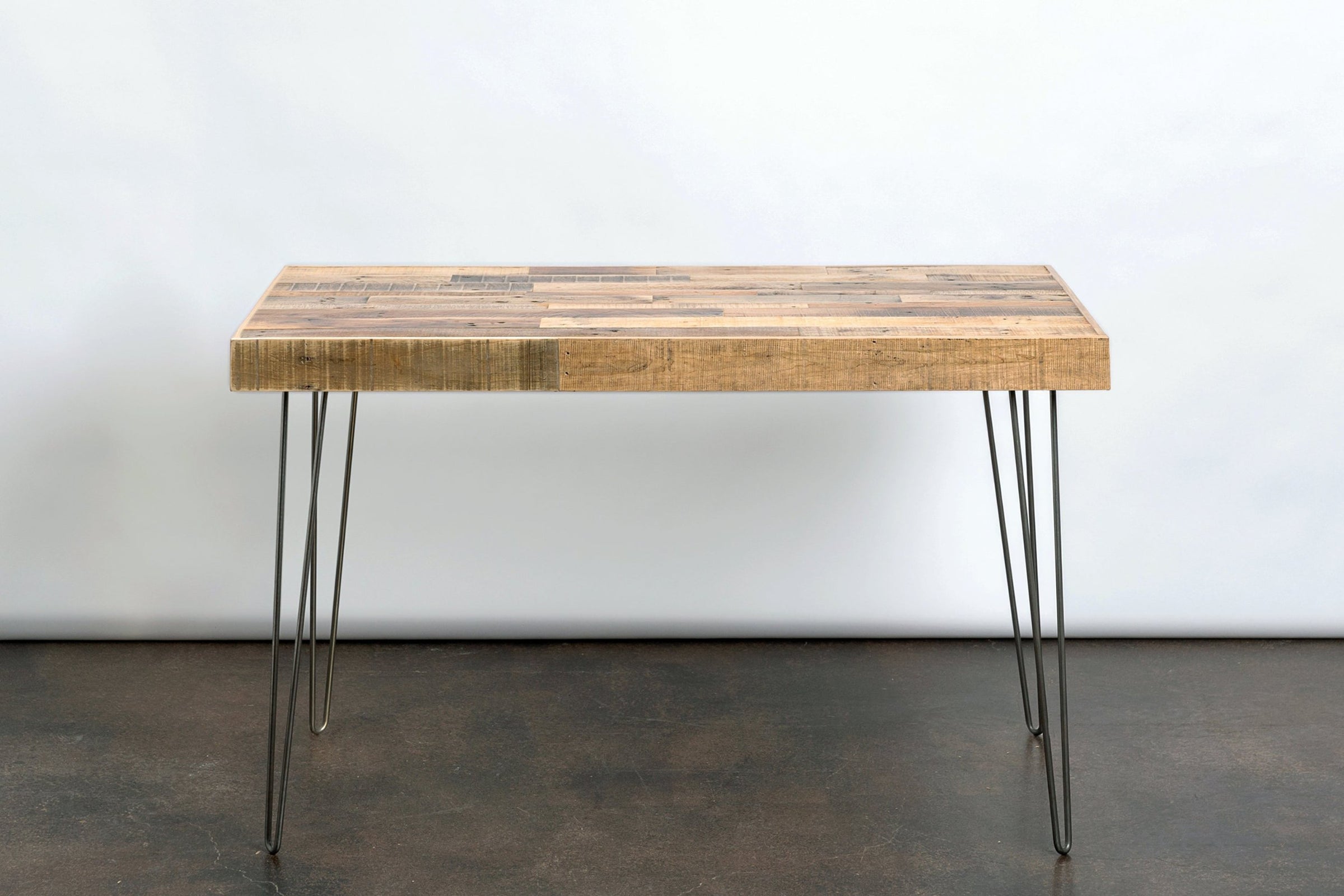 Handcrafted in Arizona, this bar-height table features a robust reclaimed wood top and sturdy steel hairpin legs. Ideal as a kitchen island, dining table, or restaurant table, it's a standout piece of reclaimed wood furniture.