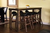 Handcrafted in Arizona, this reclaimed wood bar-height community table with five matching stools highlights enduring quality. Set on hardwood flooring, it’s an inviting dining or restaurant table with a warm yellow accent.