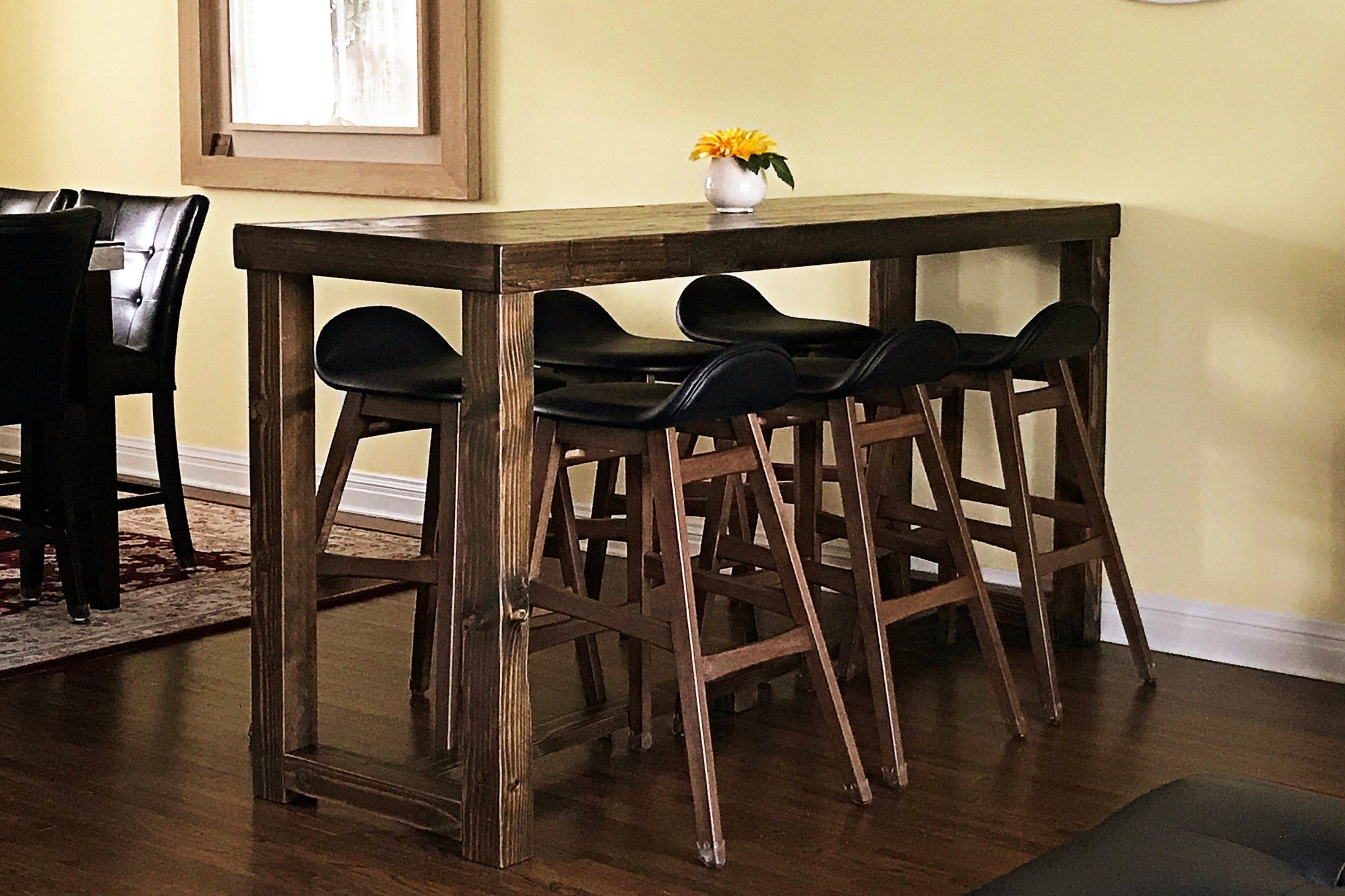 Handcrafted in Arizona, this Sequoia bar-height table set features sustainably sourced reclaimed wood and four matching stools. Ideal as a dining table or kitchen island, it blends lasting quality with timeless design. Custom sizes available.