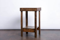 Expertly handcrafted in Arizona, this narrow reclaimed wood nightstand features a rectangular top, four straight legs, and a lower shelf. Ideal as sustainable bedroom furniture or an accent table for any space.