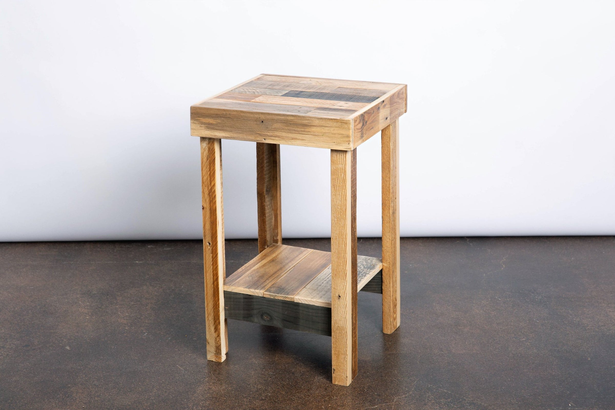 Handcrafted in Arizona, this reclaimed wood narrow side table features four sturdy legs, a square top, and a lower shelf. Perfect as an eco-friendly accent or bar-height table for your kitchen or restaurant décor.
