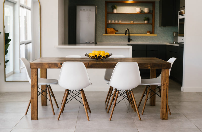 Experience timeless craftsmanship in this modern kitchen with a handcrafted reclaimed wood dining table—perfect as a dining table or restaurant table—paired with six white chairs. Black cabinets and open shelves complete the look.