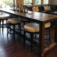 Experience timeless craftsmanship with this handcrafted Sequoia reclaimed wood bar-height table, paired with four white-cushioned stools. Ideal as a kitchen island or narrow restaurant table, showcasing sustainable materials and enduring quality.