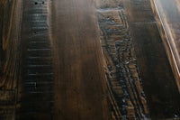 Warm close-up of a handcrafted, reclaimed wood surface with rich grain, knots, and unique textures—showcasing sustainable Arizona craftsmanship ideal for a bar table, kitchen island, or custom reclaimed wood furniture.