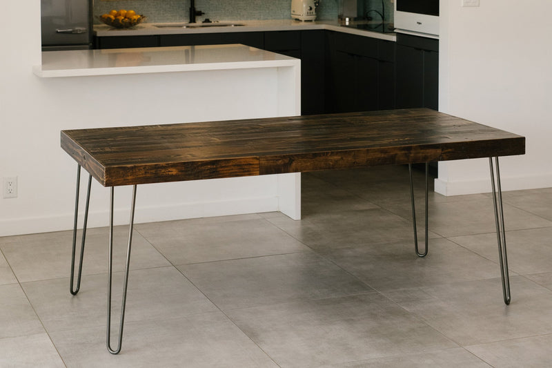 Elevate your kitchen with a handcrafted reclaimed wood dining table, featuring hairpin steel legs and artisan craftsmanship. This sustainable narrow table blends seamlessly as a versatile counter-height or restaurant table. Made in Arizona.