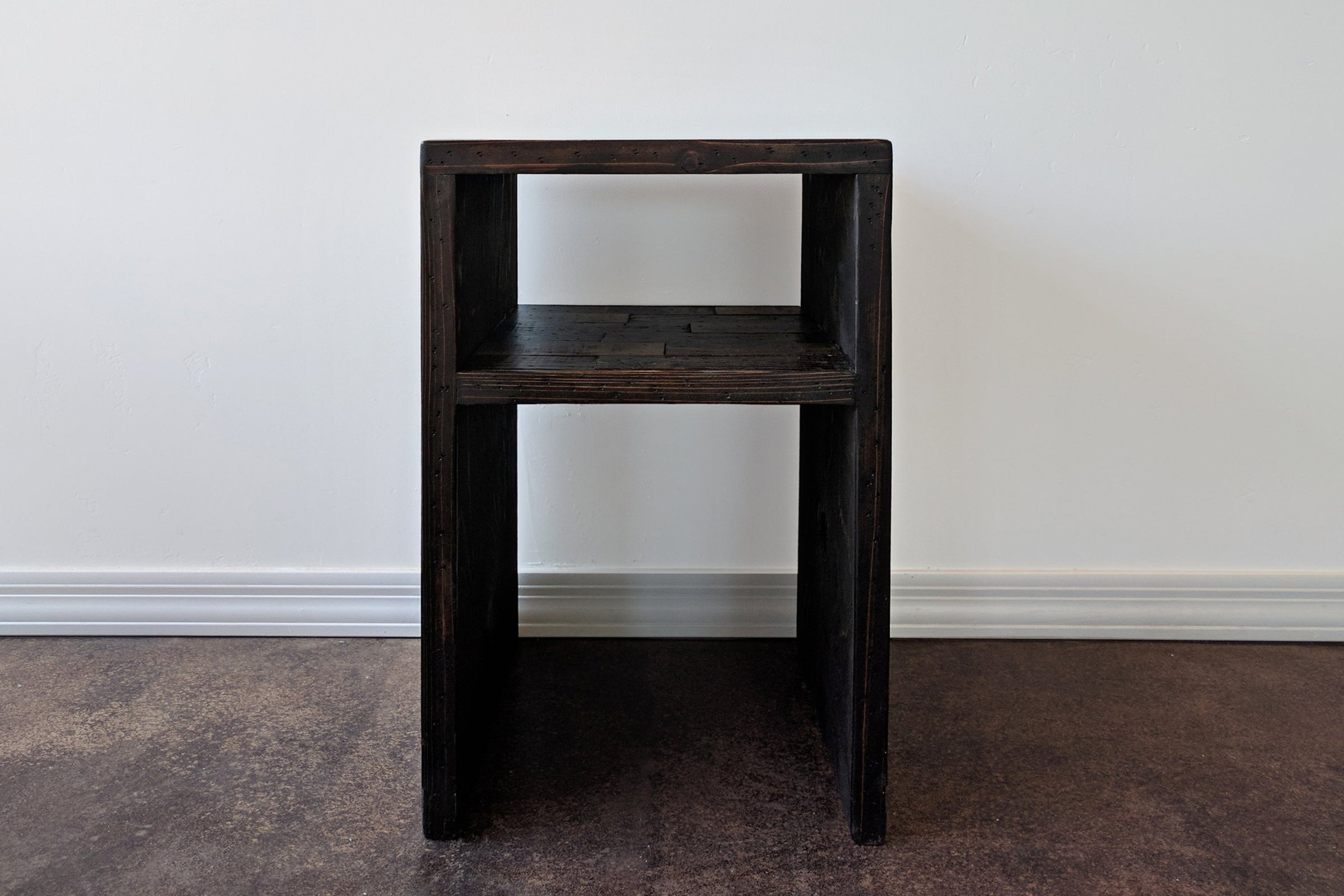 Handcrafted in Arizona, this narrow side table showcases enduring quality with its waterfall design and open shelf. Made from reclaimed wood, it's ideal as a sustainable bar-height table or accent for kitchens and restaurants.