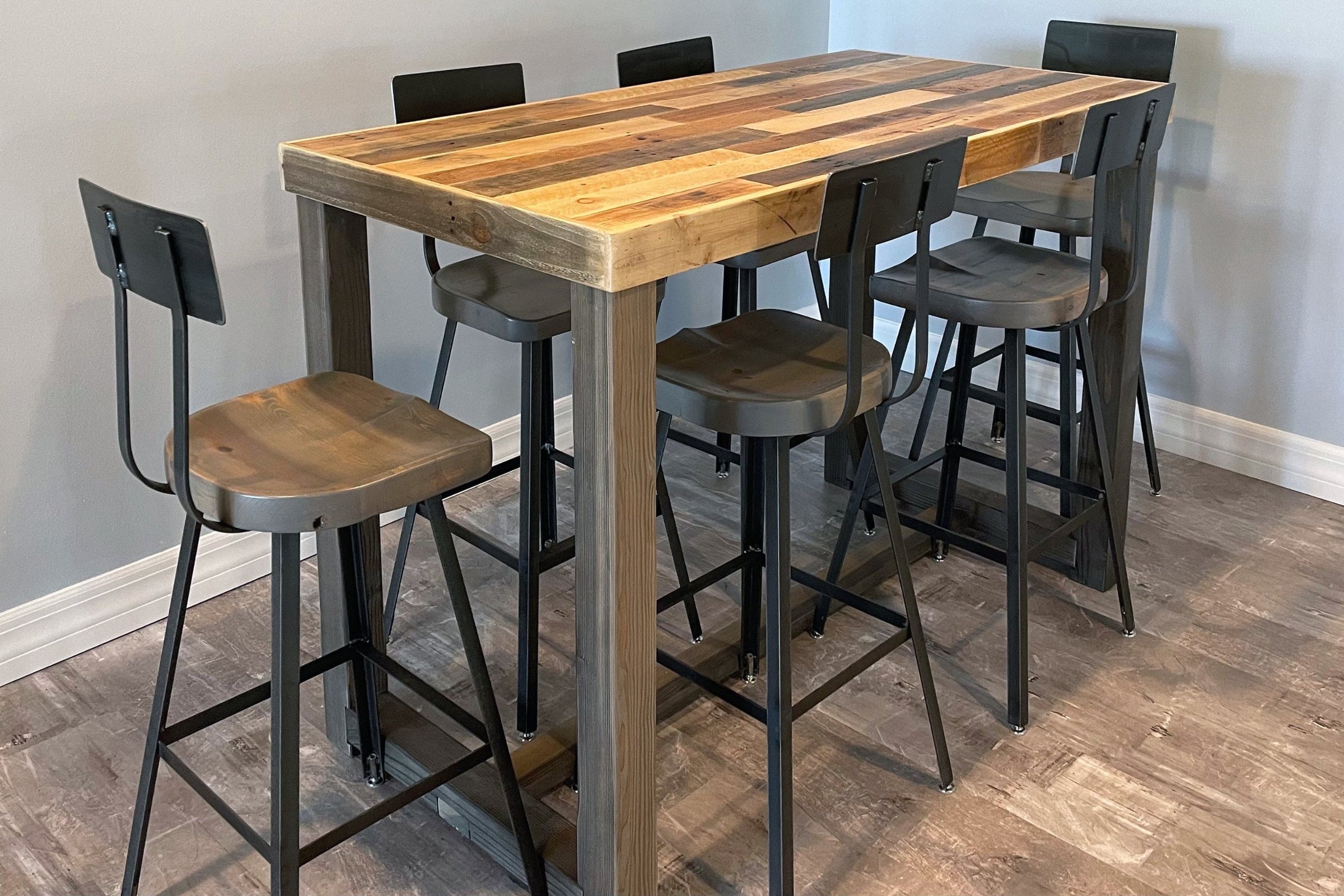Elevate your space with this handcrafted Arizona-made reclaimed wood bar-height table, featuring a rich mixed grain surface and six sturdy metal-and-wood stools. Perfect as a narrow dining table or kitchen island for sustainable style.