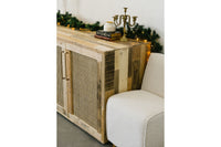 This handcrafted reclaimed wood sideboard features artisan cane doors, highlighting sustainable craftsmanship and enduring quality. Accented with greenery, string lights, and decor, it's a standout in reclaimed wood furniture.