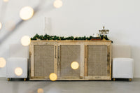 Experience timeless elegance with this handcrafted reclaimed wood sideboard, designed for enduring quality. Accented by festive garlands and artisan candles, this piece exemplifies sustainable furniture craftsmanship.