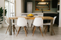 This inviting dining area showcases a handcrafted reclaimed wood dining table—expertly made in Arizona—paired with six white chairs. Sustainable materials and timeless craftsmanship reflect enduring quality, ideal for modern kitchens or restaurants.
