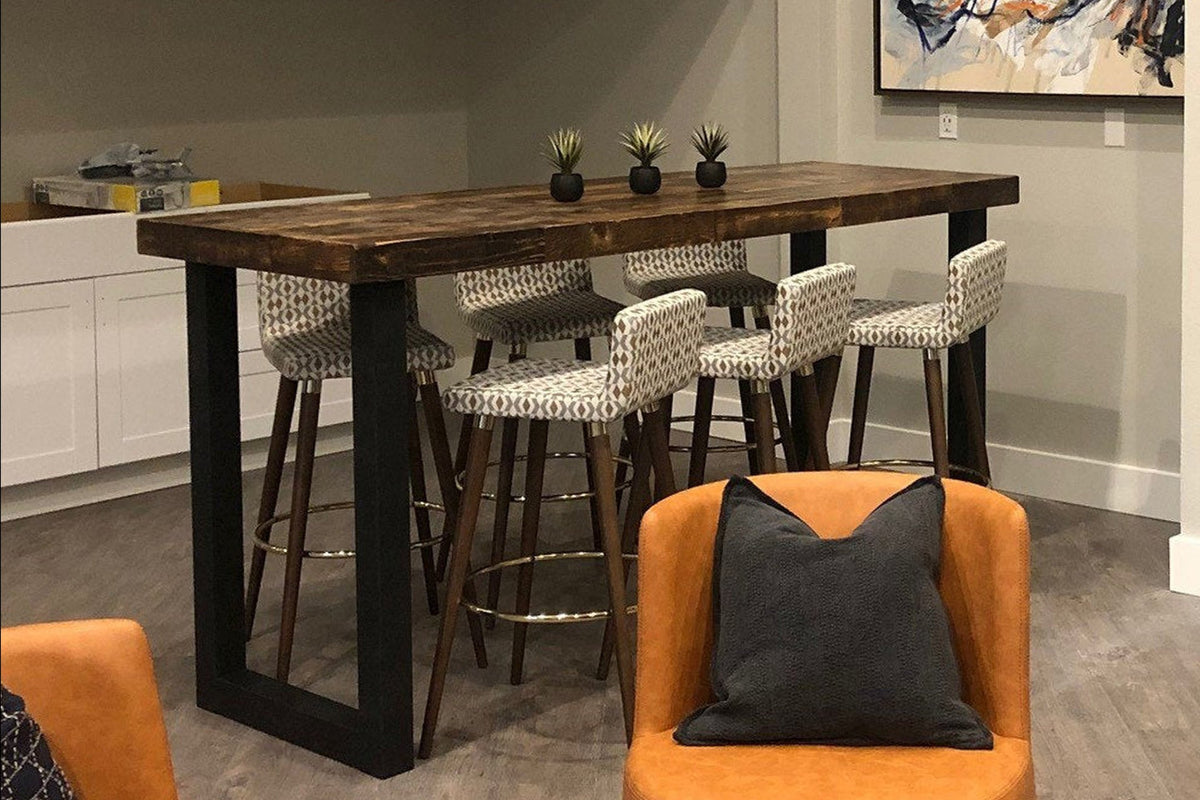 Experience timeless craftsmanship with this bar-height table, expertly handcrafted in Arizona from reclaimed wood and featuring a sturdy black steel base. Surrounded by patterned stools, it's perfect as a kitchen island or restaurant table.