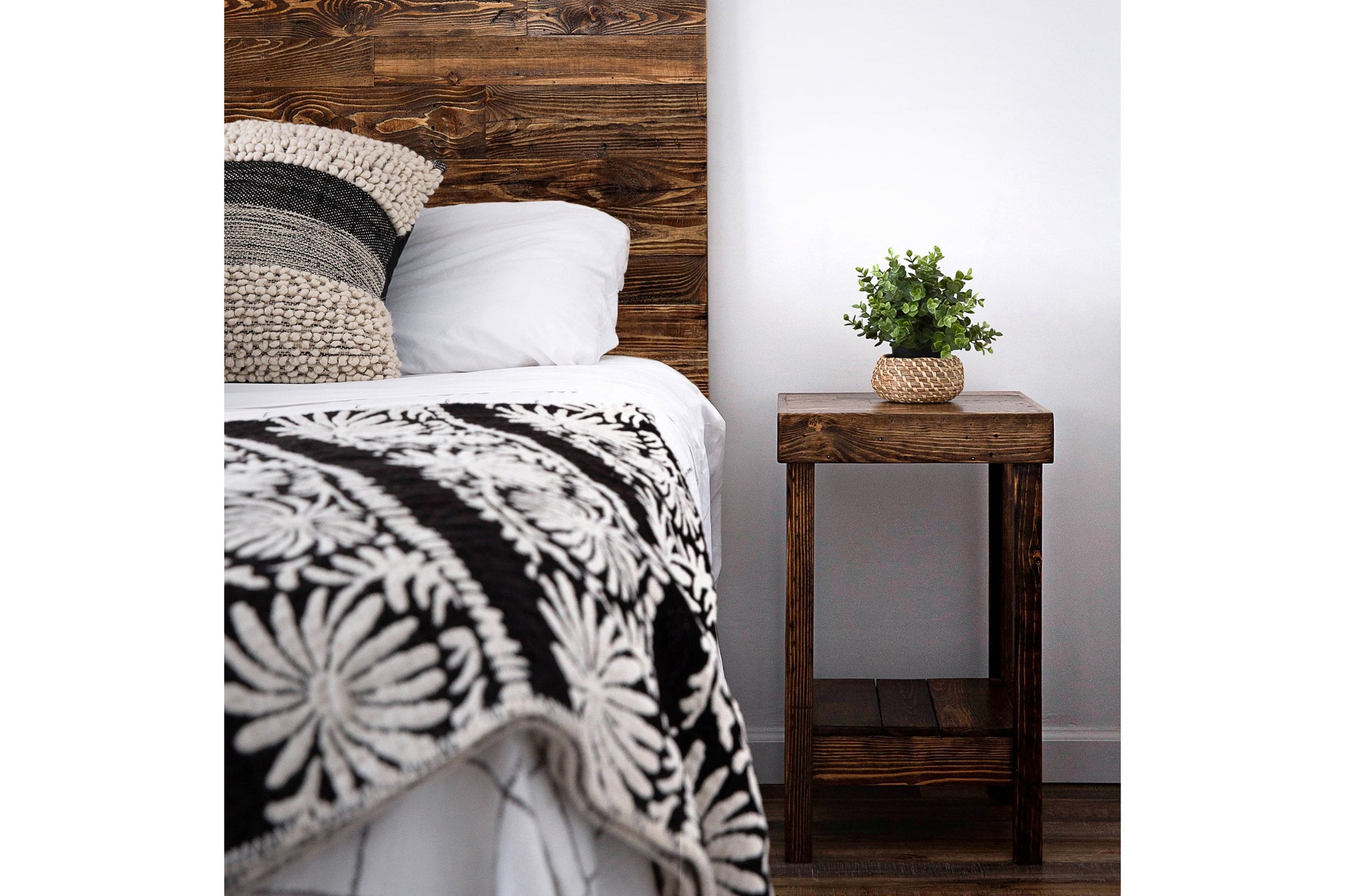 This inviting bedroom showcases a handcrafted reclaimed wood headboard and Arizona-made nightstand, highlighting artisanal woodworking. Natural finishes, sustainable materials, and enduring quality define this refined furniture piece.