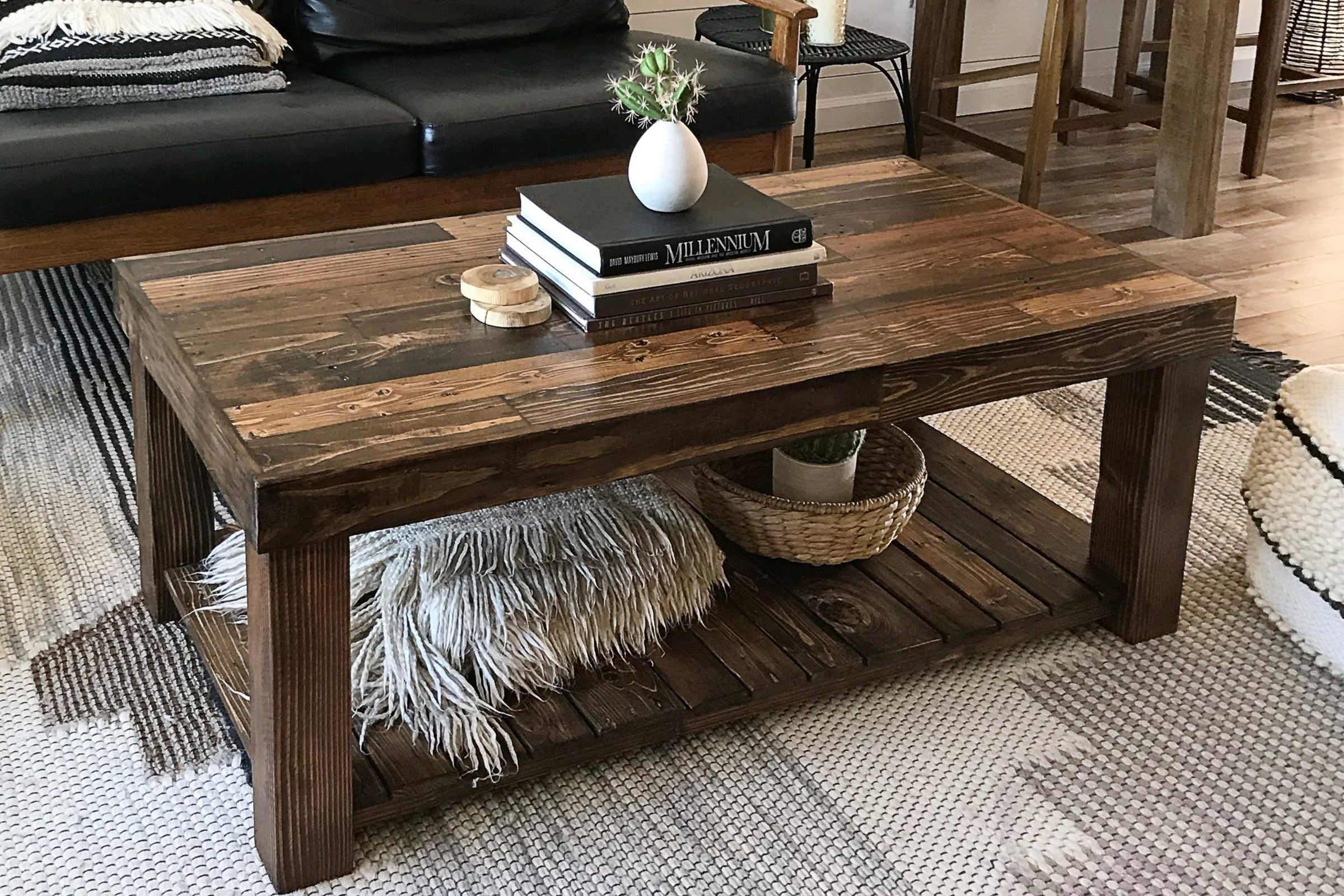 Elevate your living space with this handcrafted reclaimed wood coffee table. Showcasing artisan craftsmanship, this sustainable rectangle table features a lower storage shelf—perfect for eco-friendly, enduring reclaimed wood furniture.