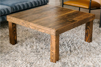 This handcrafted, square coffee table showcases enduring quality with its natural finish and rustic design, crafted from reclaimed wood. Ideal as a reclaimed wood furniture accent for living rooms or lounge seating areas.