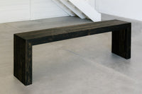 This handcrafted reclaimed wood bench showcases enduring quality and refined design, perfect as a narrow entryway table or restaurant bench. Its sustainable black finish pairs beautifully with minimalist spaces.