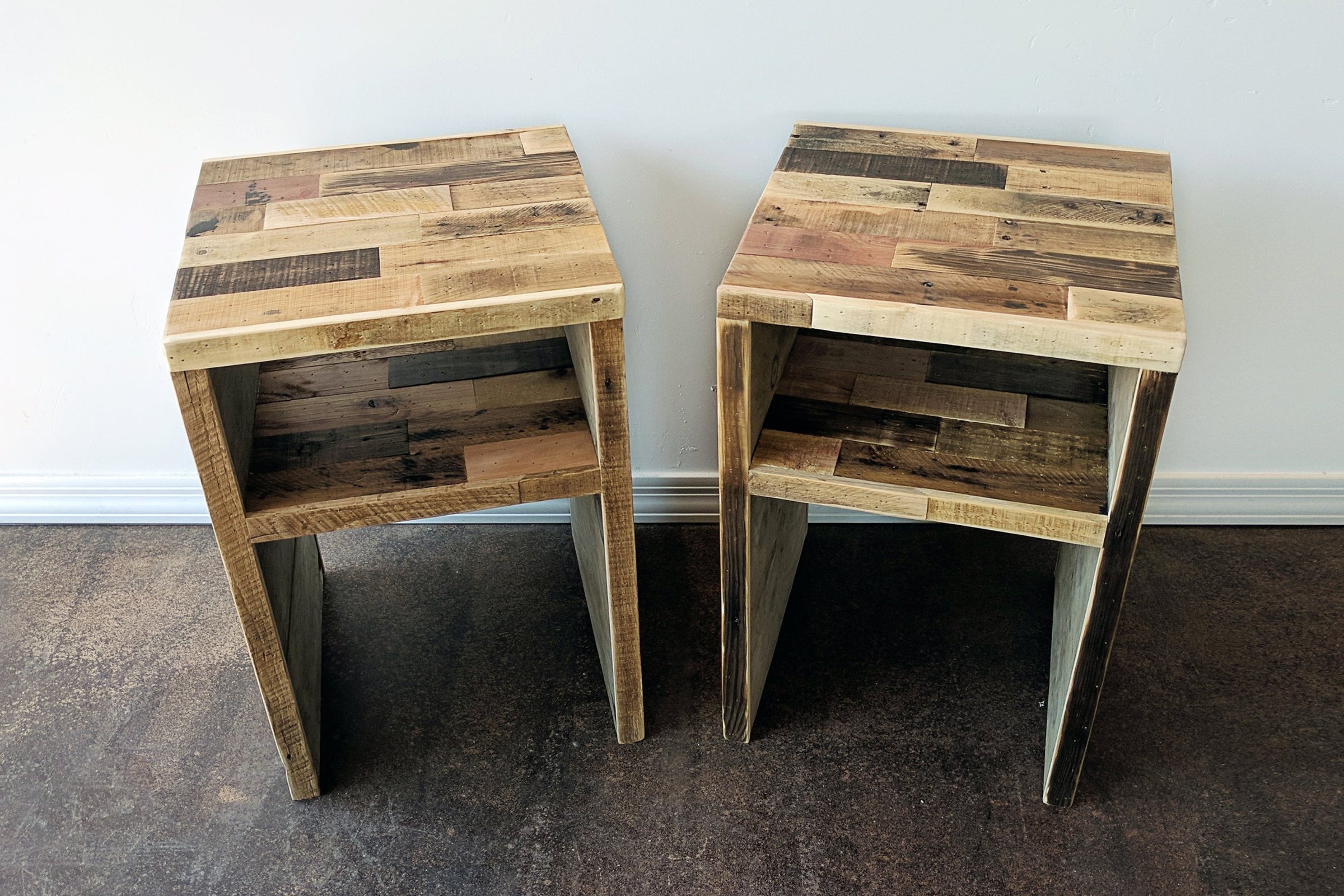 Expertly handcrafted in Arizona, these narrow side tables showcase artisan patchwork tops of sustainably sourced reclaimed wood. Each piece offers a lower shelf for storage—ideal as kitchen islands or reclaimed wood furniture accents.