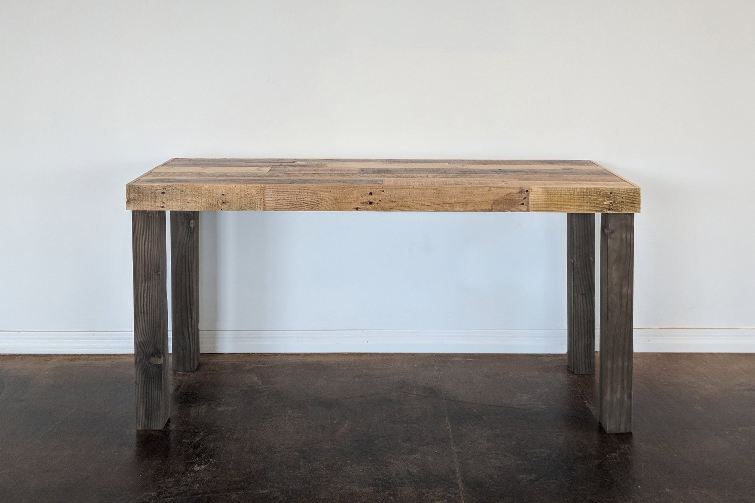 This handcrafted bar-height table features a rectangular reclaimed wood top and four sturdy legs, showcasing enduring quality and sustainable materials. Perfect as a narrow kitchen island or restaurant table, made in Arizona.