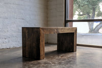 This handcrafted reclaimed wood desk features sturdy, thick legs and a rustic finish, showcasing sustainable craftsmanship. Perfect as a narrow bar-height table or dining table, it elevates any space with timeless quality.