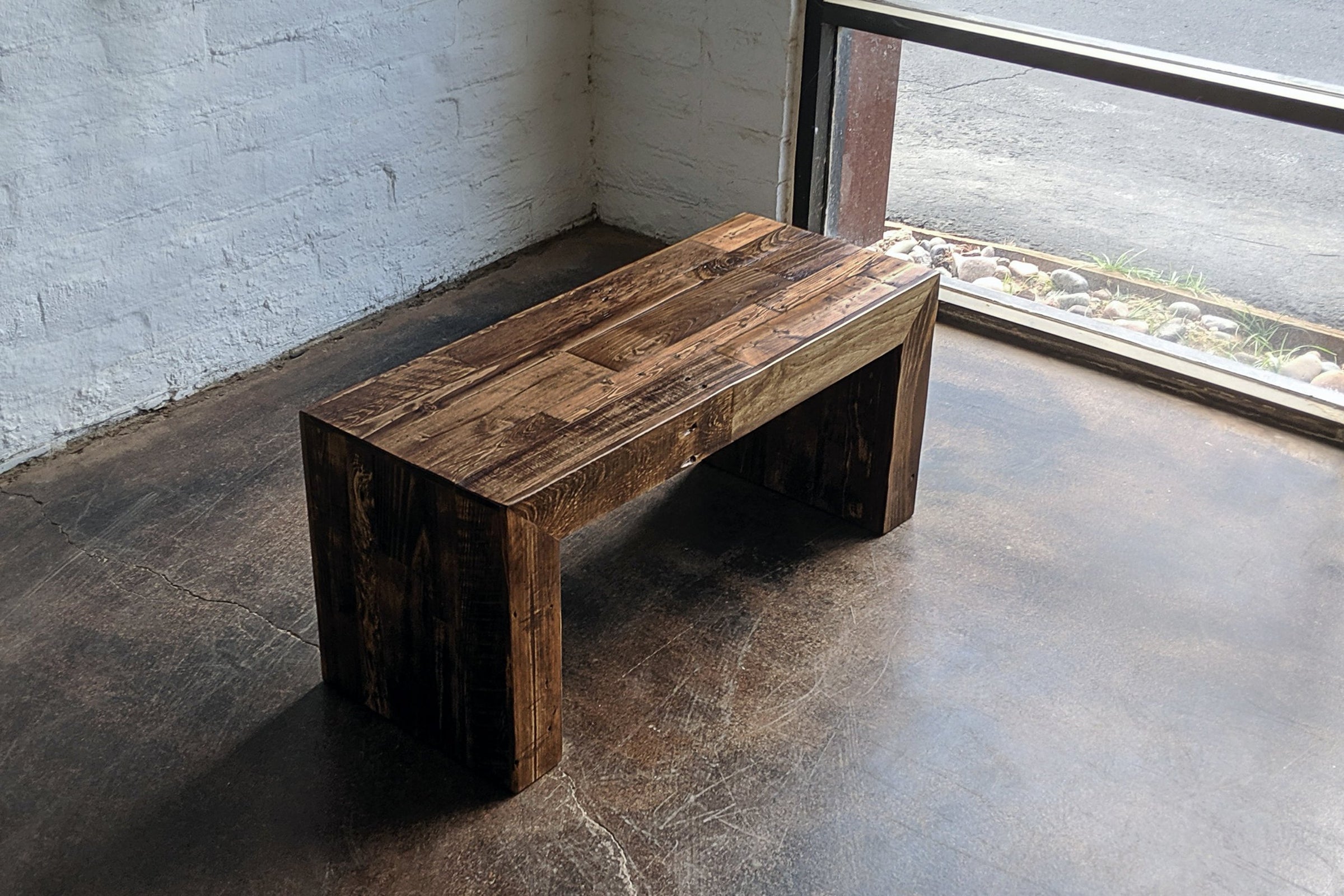 Experience timeless design with this handcrafted reclaimed wood bench, expertly finished in a rich dark tone. Ideal as a narrow dining table or restaurant table, it highlights sustainable materials and artisan quality for enduring appeal.