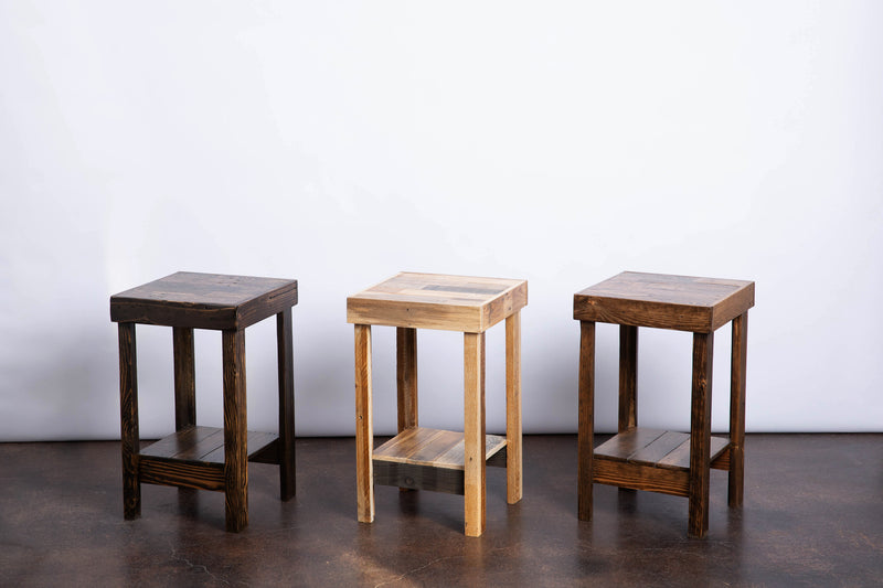 Three handmade reclaimed wood side tables in different finishes.