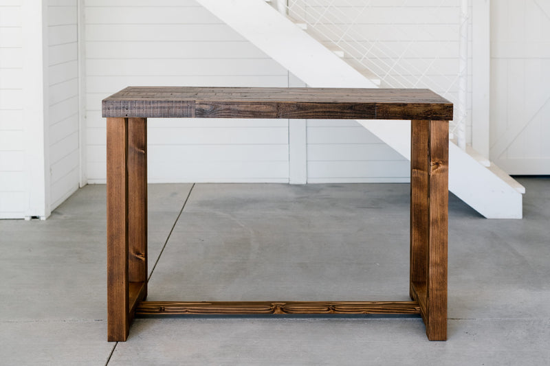 Handcrafted in Arizona, this bar-height table features a rectangular reclaimed wood top and robust legs, showcasing artisan craftsmanship. Perfect as a kitchen island, restaurant table, or narrow dining table.