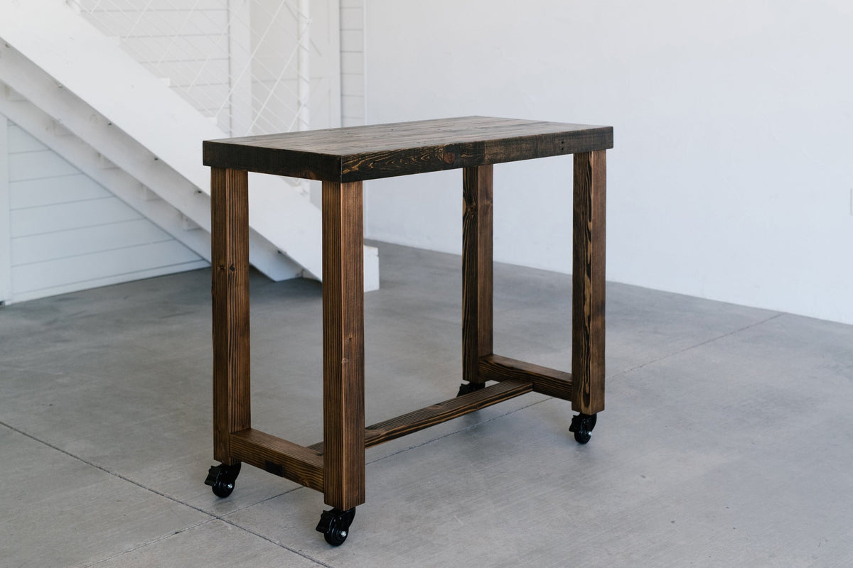 Reclaimed wood table with sturdy black caster wheels that roll and lock, handcrafted in Arizona.