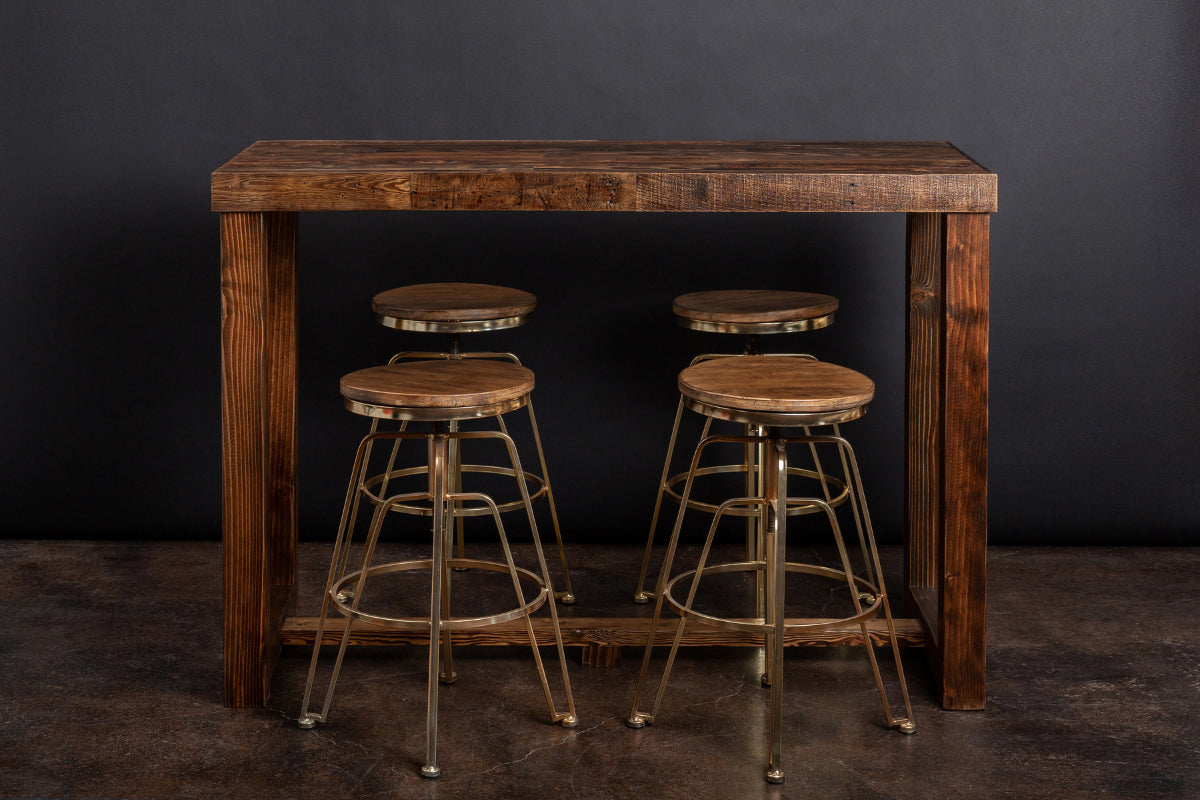 This handcrafted bar-height table, made from sustainably sourced wood and paired with four round barstools featuring sturdy metal legs, offers enduring quality—ideal as a sleek kitchen island or narrow dining table.