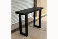 Gunnison steel leg table with black finish reclaimed wood top outside of Kase Custom's Arizona woodshop.