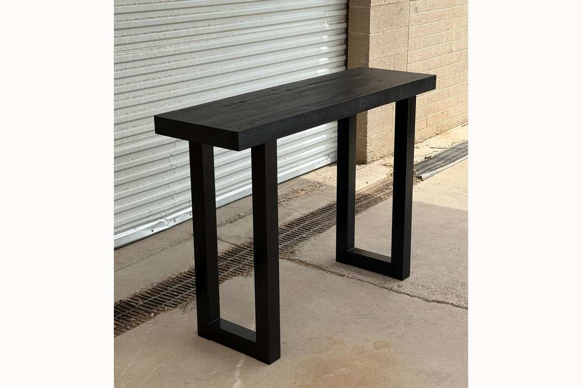 Gunnison steel leg table with black finish reclaimed wood top outside of Kase Custom's Arizona woodshop.