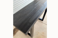 Close up of black reclaimed wood finish on Gunnison steel leg table.