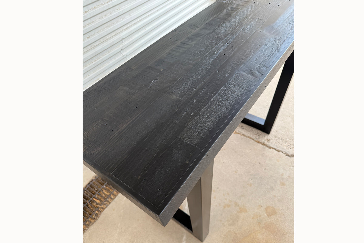 Close up of black reclaimed wood finish on Gunnison steel leg table.