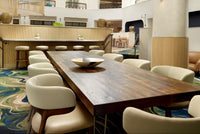 Custom reclaimed wood communal conference table installed in Marriott Renaissance hotel lobby, handcrafted by Kase Custom