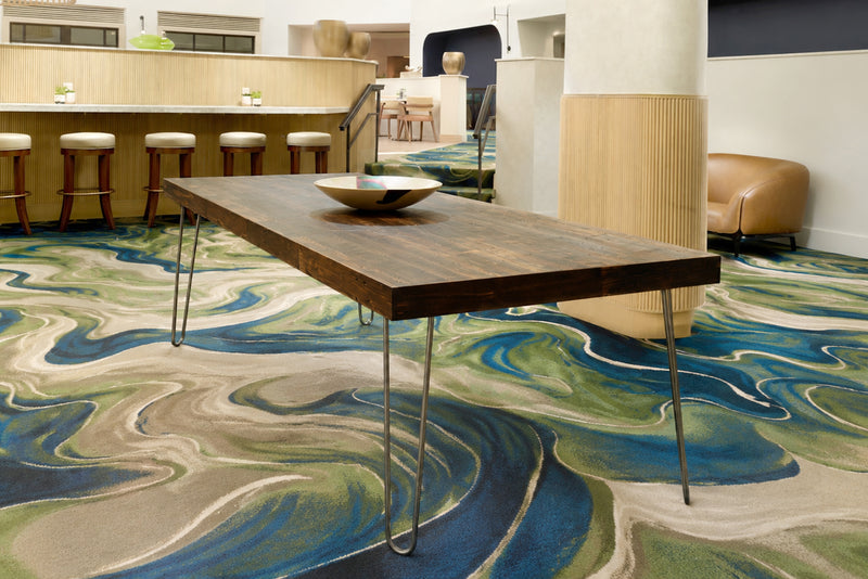 Experience enduring quality with this handcrafted bar-height table, featuring a reclaimed wood top and sleek steel hairpin legs. Set in a modern space with bar stools, it's perfect as a kitchen island or restaurant table.