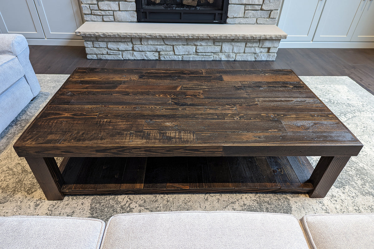 Rustic wooden coffee table in a living room setting with a fireplace and sofa.