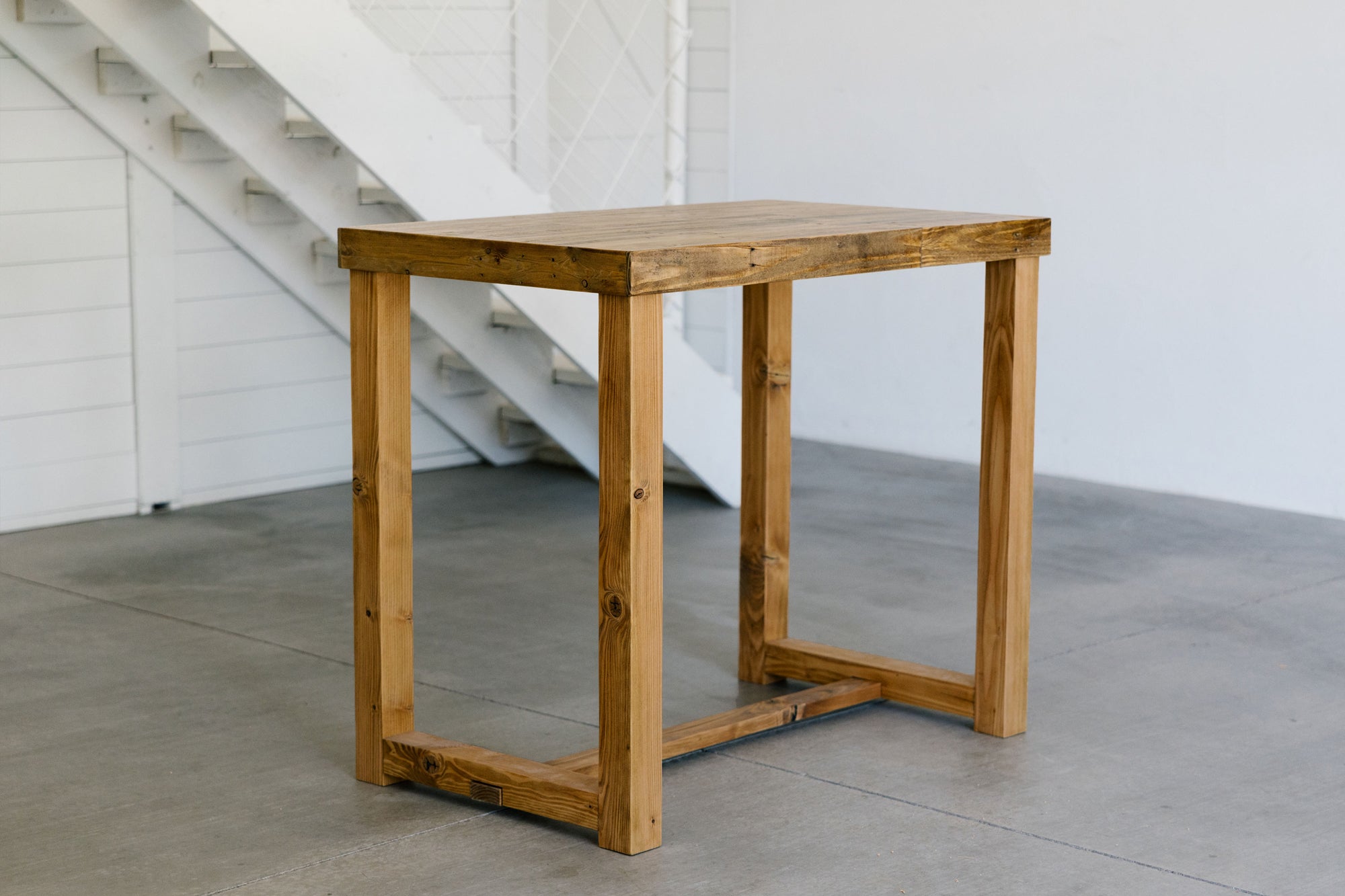 Handcrafted in Arizona, this solid wood bar-height table features a Golden Oak finish and timeless craftsmanship. Ideal as a kitchen island, narrow dining table, or restaurant table, it reflects enduring quality and sustainable design.