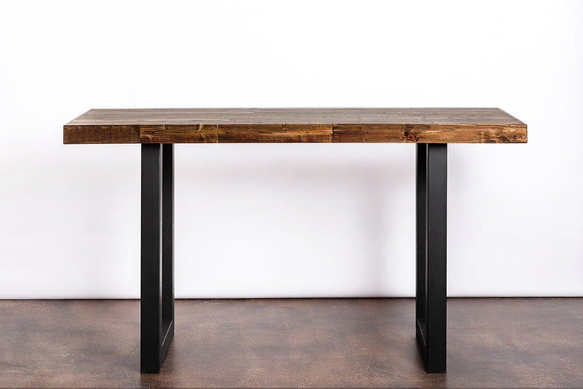 This handcrafted Arizona bar-height table features a thick, rustic reclaimed wood top and durable black steel legs. Ideal as a narrow dining table, kitchen island, or restaurant table—showcasing sustainable style and lasting quality.