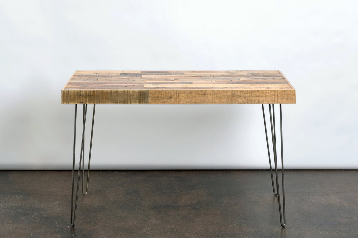 This handcrafted reclaimed wood desk features a light-toned Natural top and sturdy steel hairpin legs, blending sustainable materials with timeless durability.
