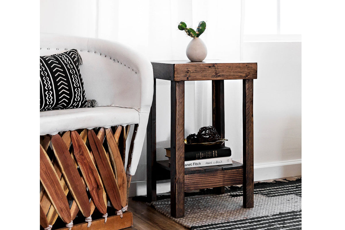 This handcrafted narrow reclaimed wood side table features a sturdy lower shelf for books and decor, exemplifying sustainable craftsmanship. Ideal for use as an accent or bar-height table in modern or rustic spaces.