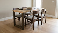 Expertly handcrafted in Arizona, this reclaimed wood bar-height table with four chairs is set on a light wood floor. Durable and sustainable, this narrow dining table brings timeless style to any kitchen or restaurant space.