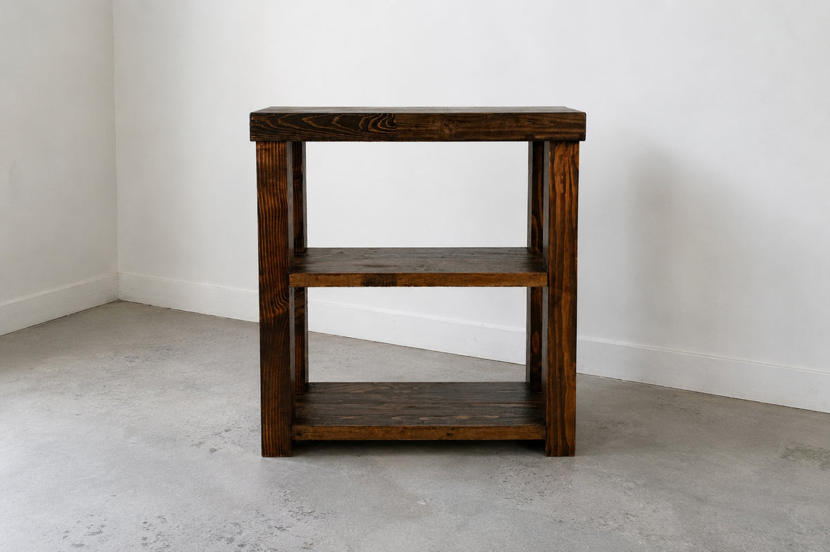 Provincial finish solid wood coffee bar on concrete floor in front of white wall. 