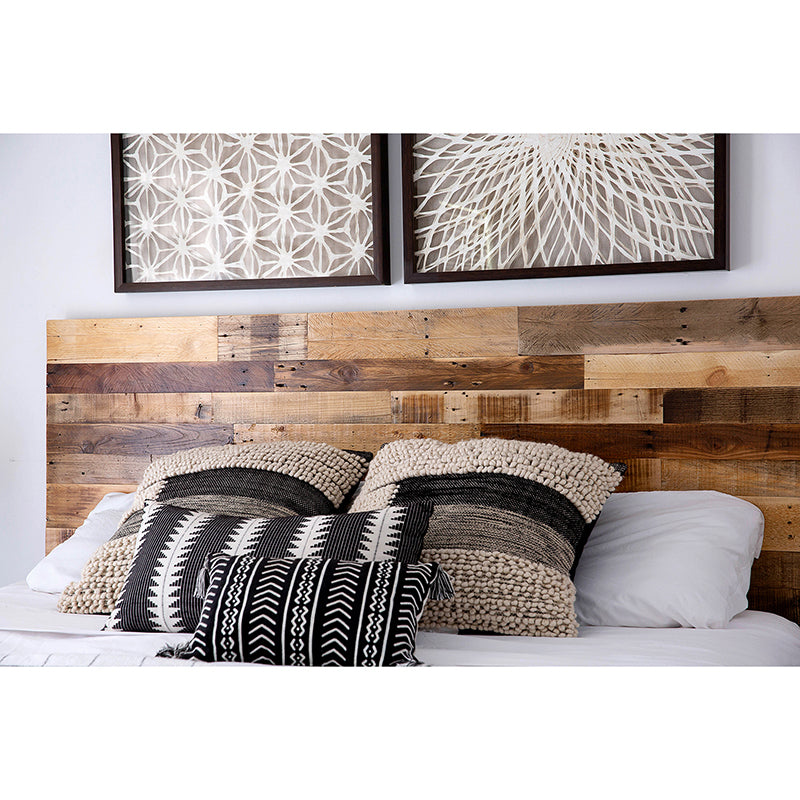 Reclaimed wood headboard in Natural behind bed with pillows