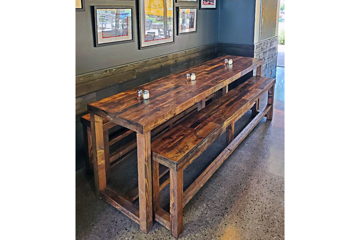 Experience enduring quality with our handcrafted reclaimed wood dining table and bench, perfect as a restaurant table or narrow kitchen island. Set on polished concrete, their warm finish and artisan craftsmanship stand out seamlessly.