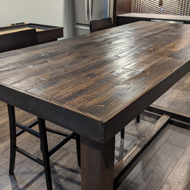 Counter height reclaimed wood table in dark espresso finish.